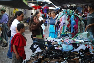 Women shop for clothes in the open-air market